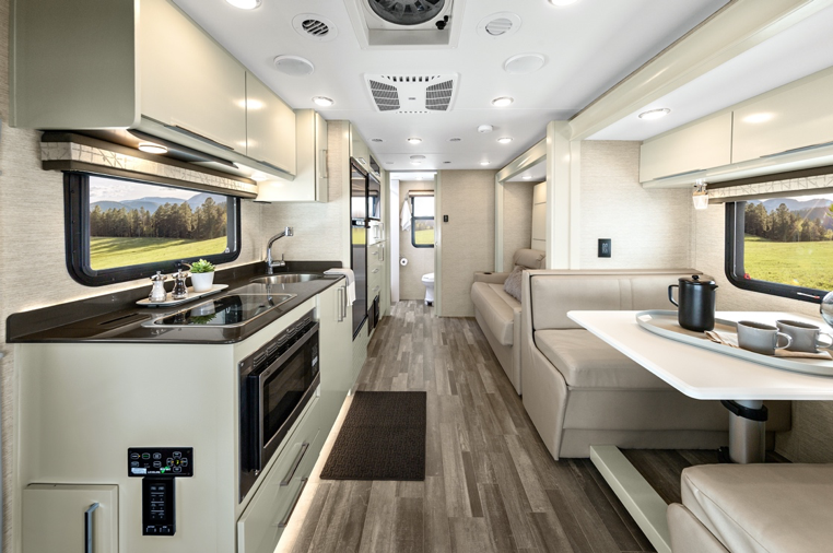 The interior of the 2020 Tiffin Wayfarer featuring a dinette and murphy bed.