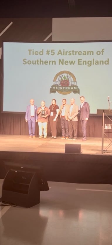 The Campers Inn team receives their plaque
