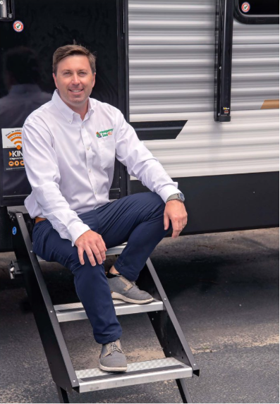 Daniel sits on one of Campers Inns private-label RVs