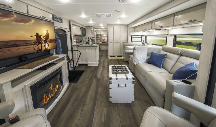 The interior of the new 2020 Winnebago Forza featuring a fireplace and LED Television.