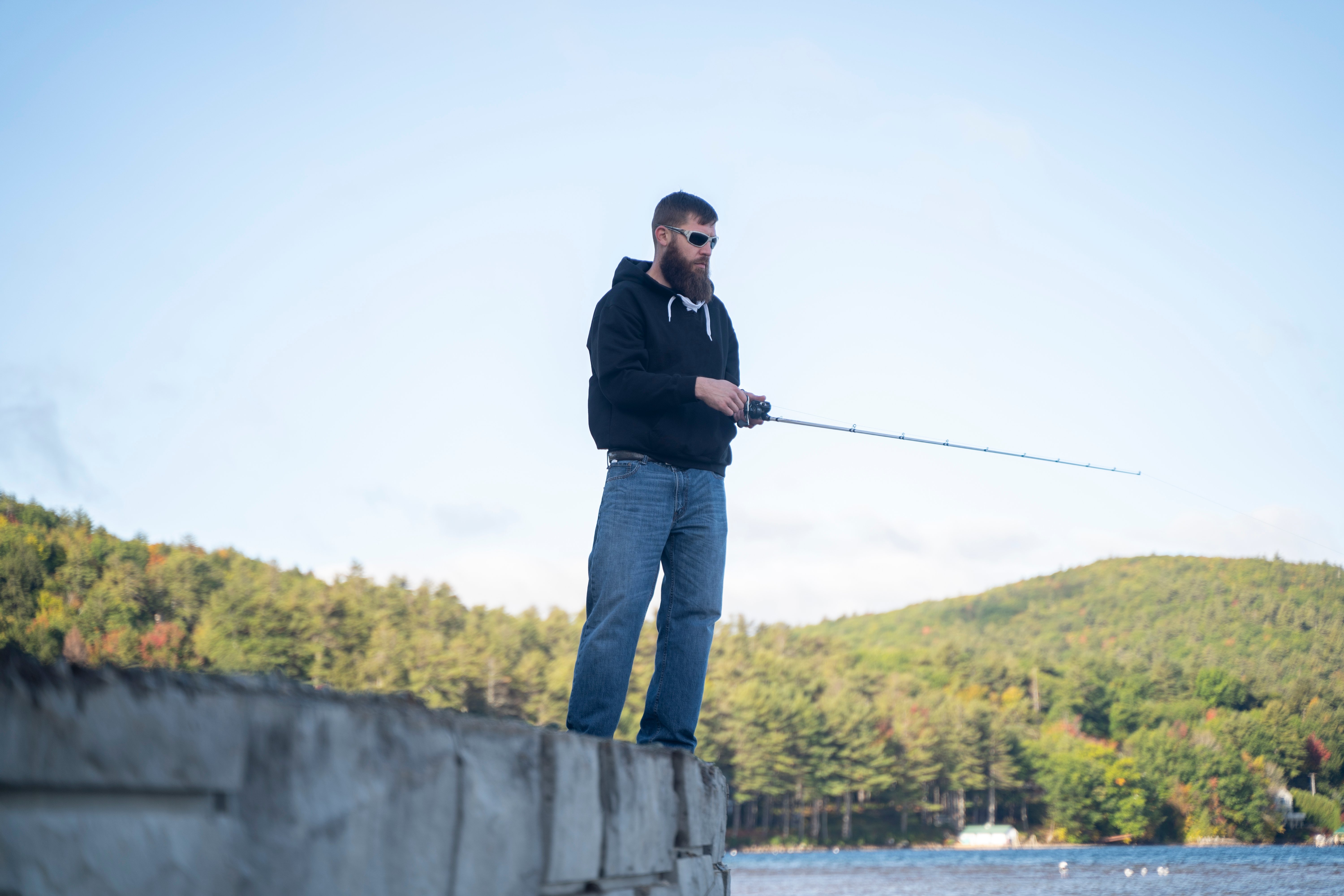 man fishing on a lake in the mountains