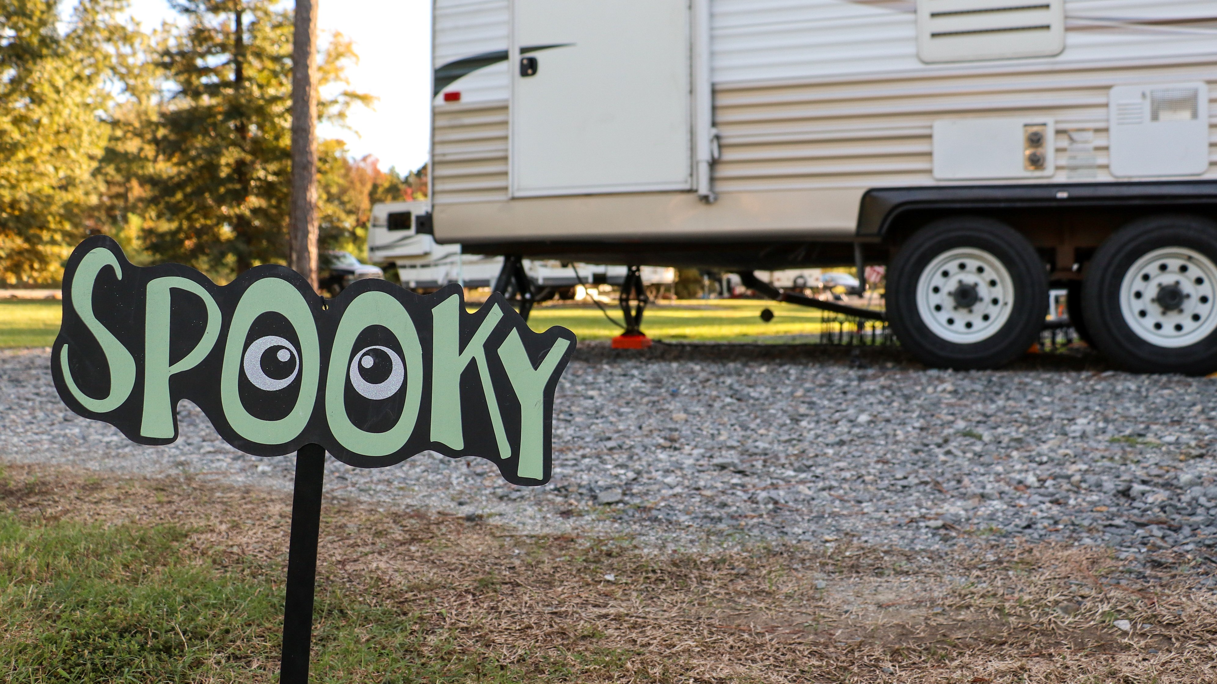 a spooky halloween sign at a campsite