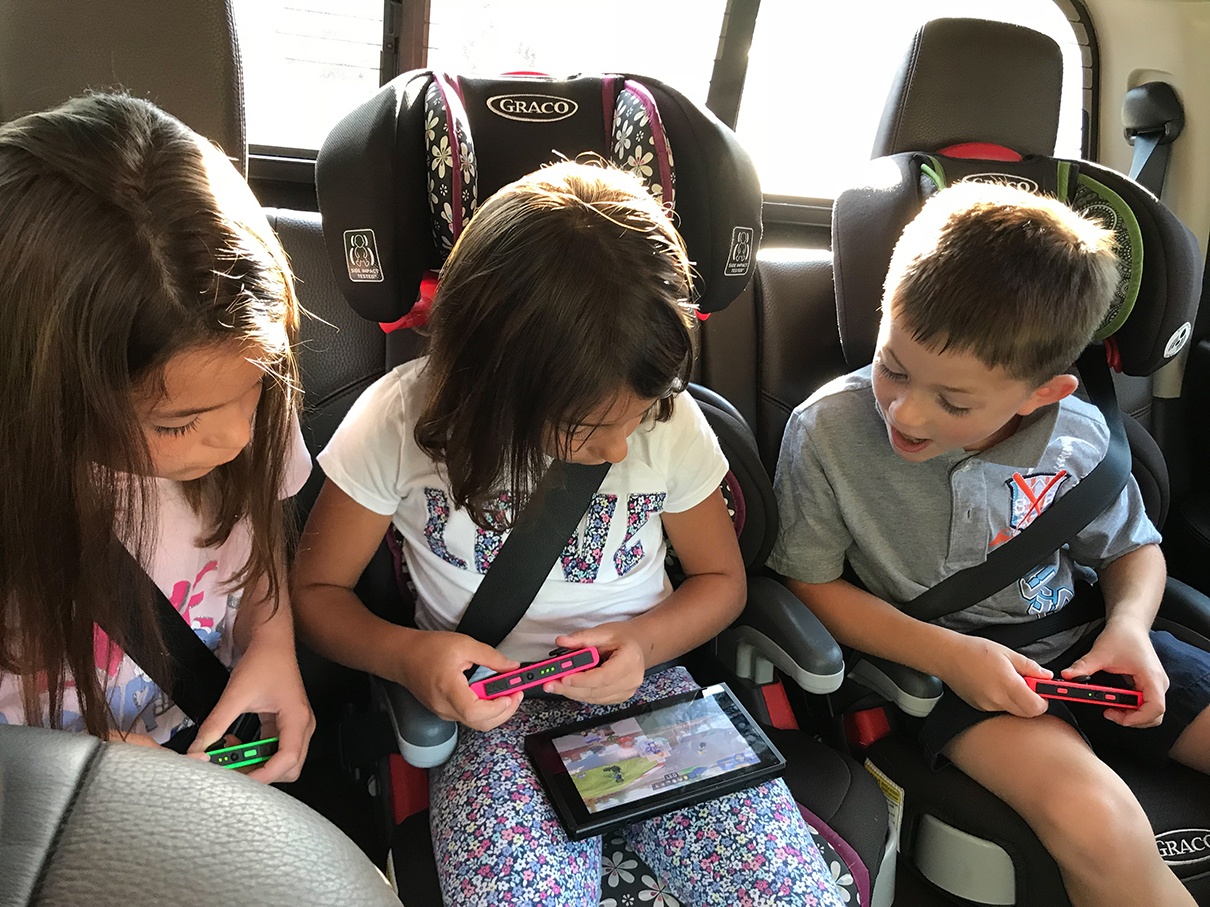 The Hirsch family enjoys their tablet computer while they travel in their Grand Design Reflection Travel Trailer