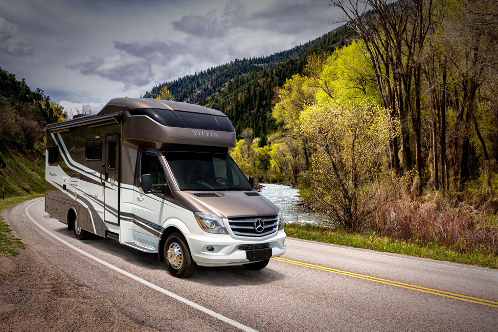 The exterior of the 2020 Tiffin Wayfarer driving on winding roads. 