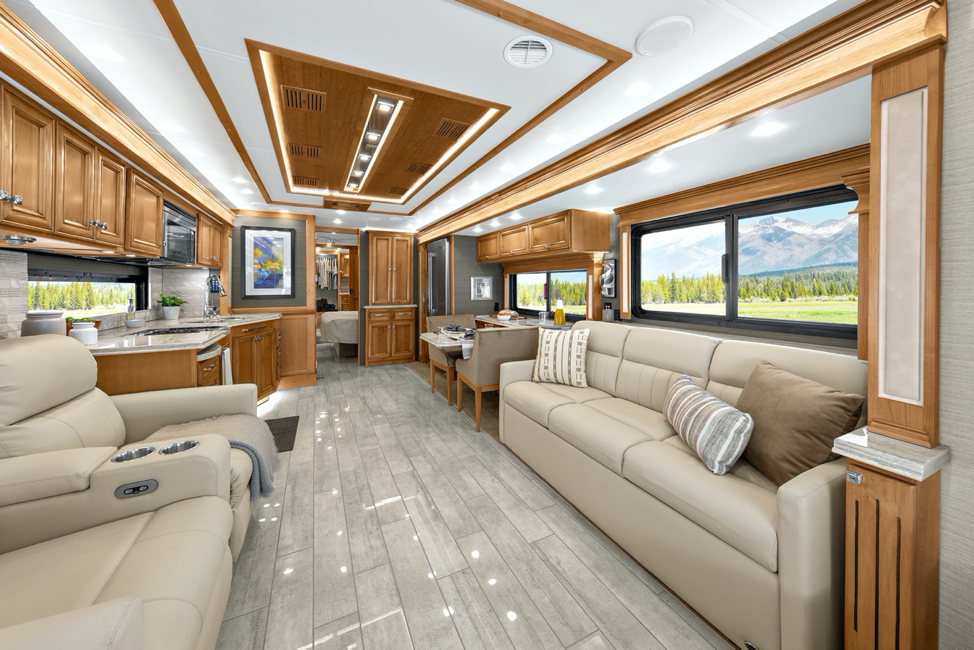 The living room of the 2020 Tiffin Phaeton featuring two recliner theater seats. 