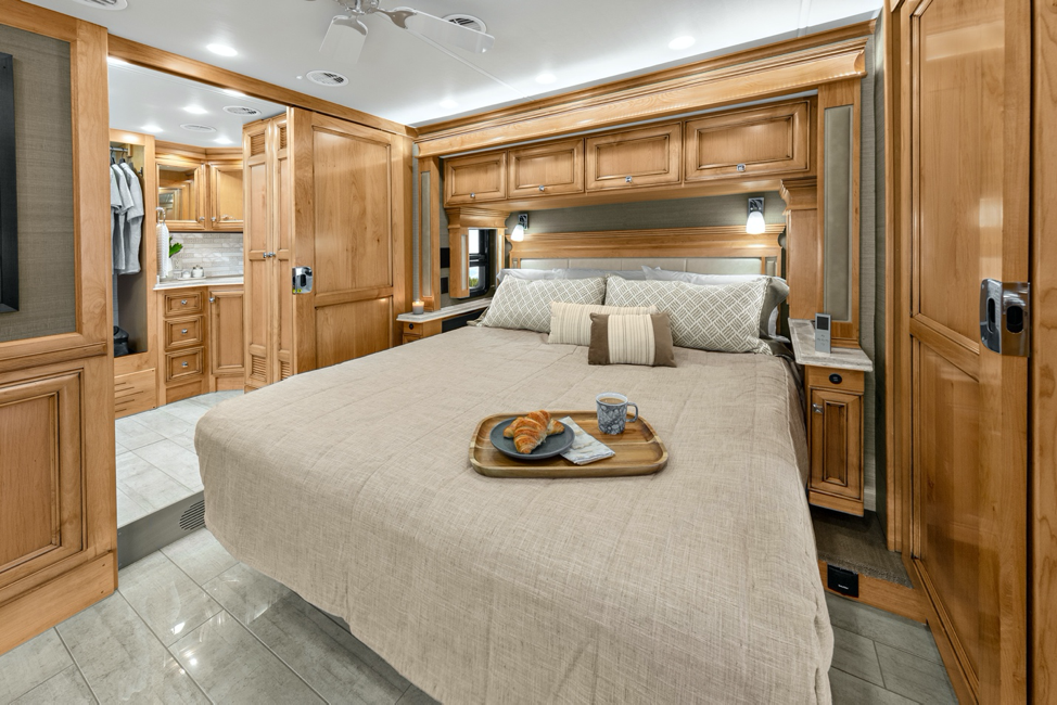 The interior of the 2020 Tiffin Phaeton, featuring a master bedroom with a king bed