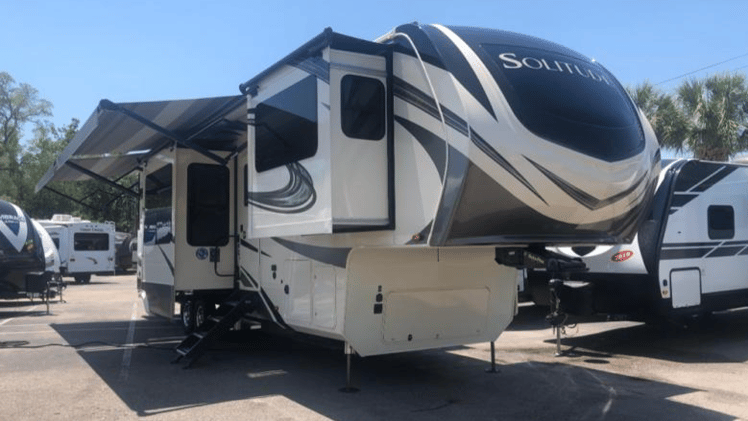 Exterior of the 2020 Grand Design Solitude 380FL-R fifth wheel featuring five slideouts and a 12-foot awning. 