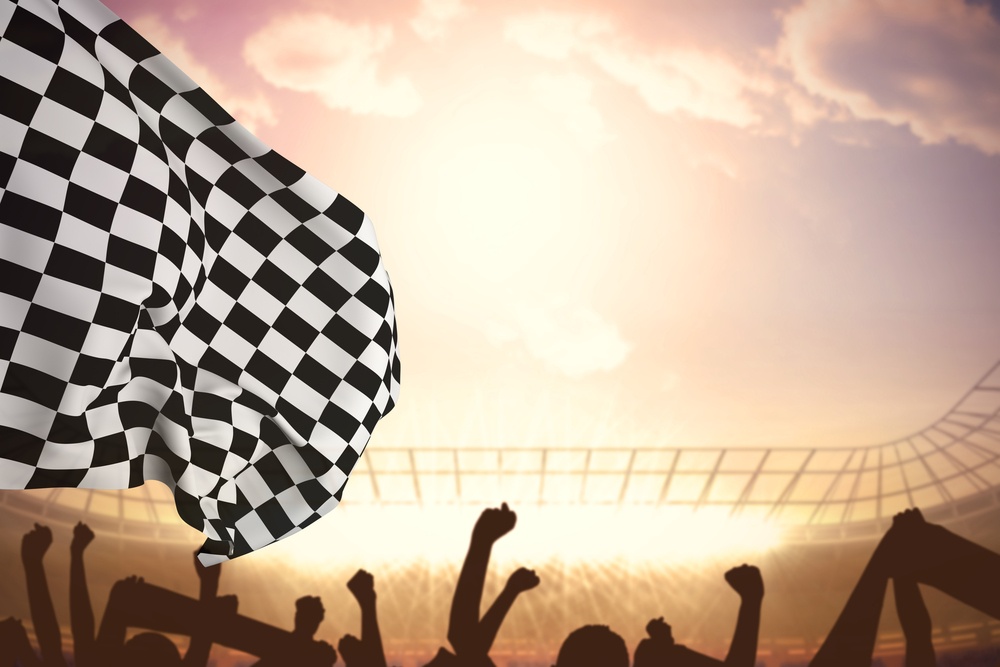Checkered flag against football stadium with cheering crowd.jpeg