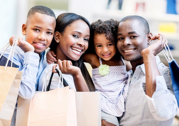 Happy shopping family smiling together at the mall .jpeg