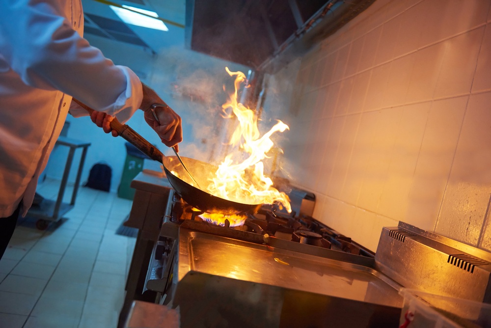 chef in hotel kitchen prepare vegetable  food with fire.jpeg