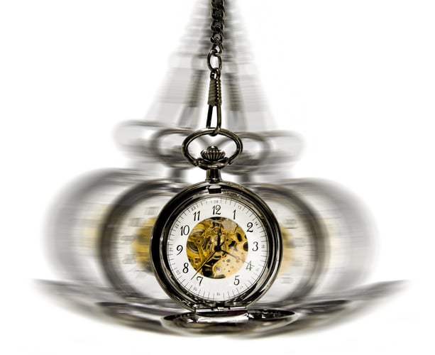 clock in motion over white - hypnotism concept.jpeg