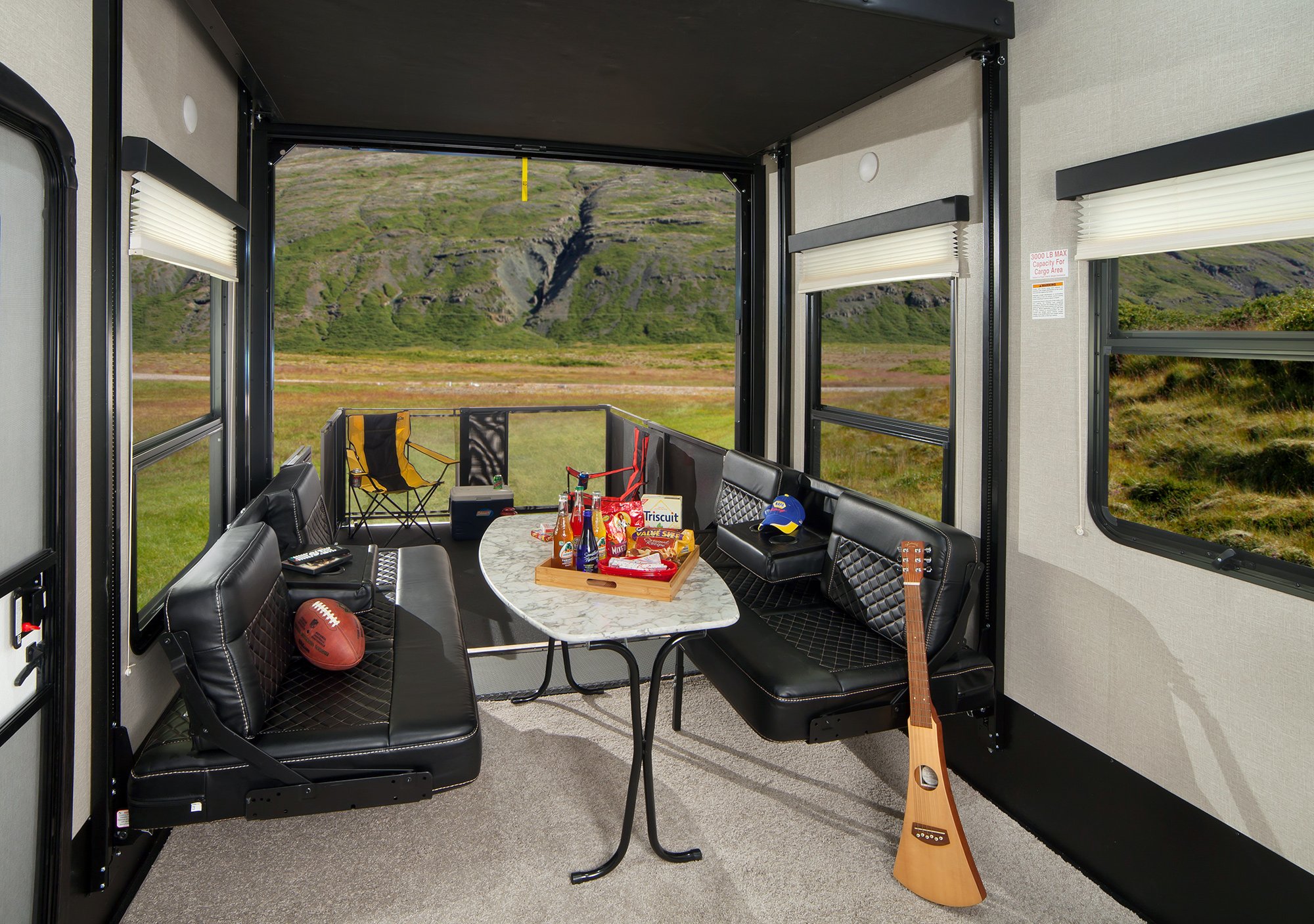 a fifth wheel toy hauler garage set up as a dining area and porch