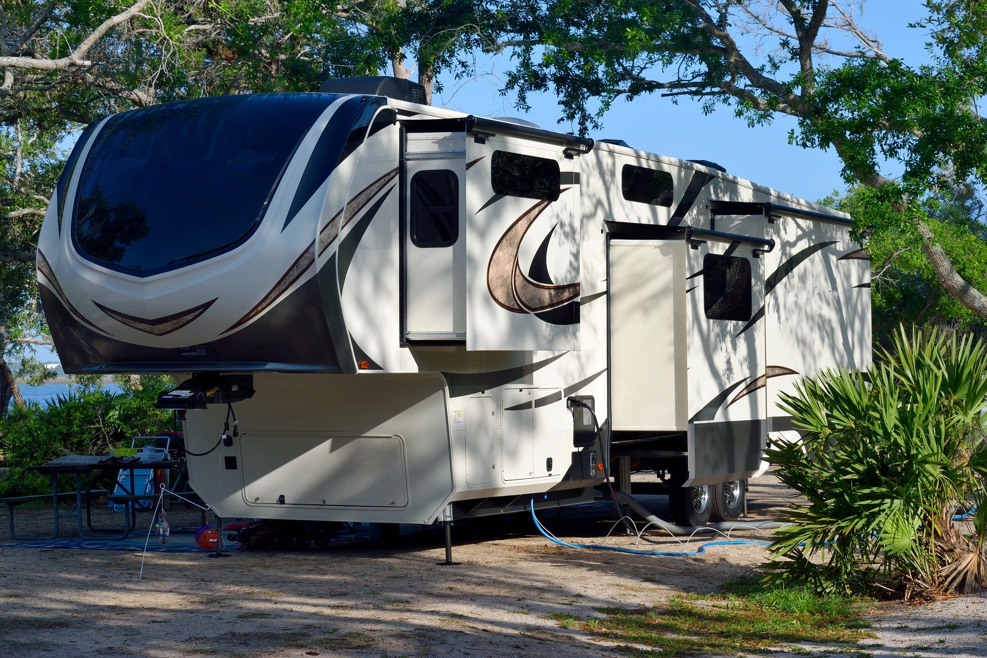 a fifth wheel trailer set up at a campsite