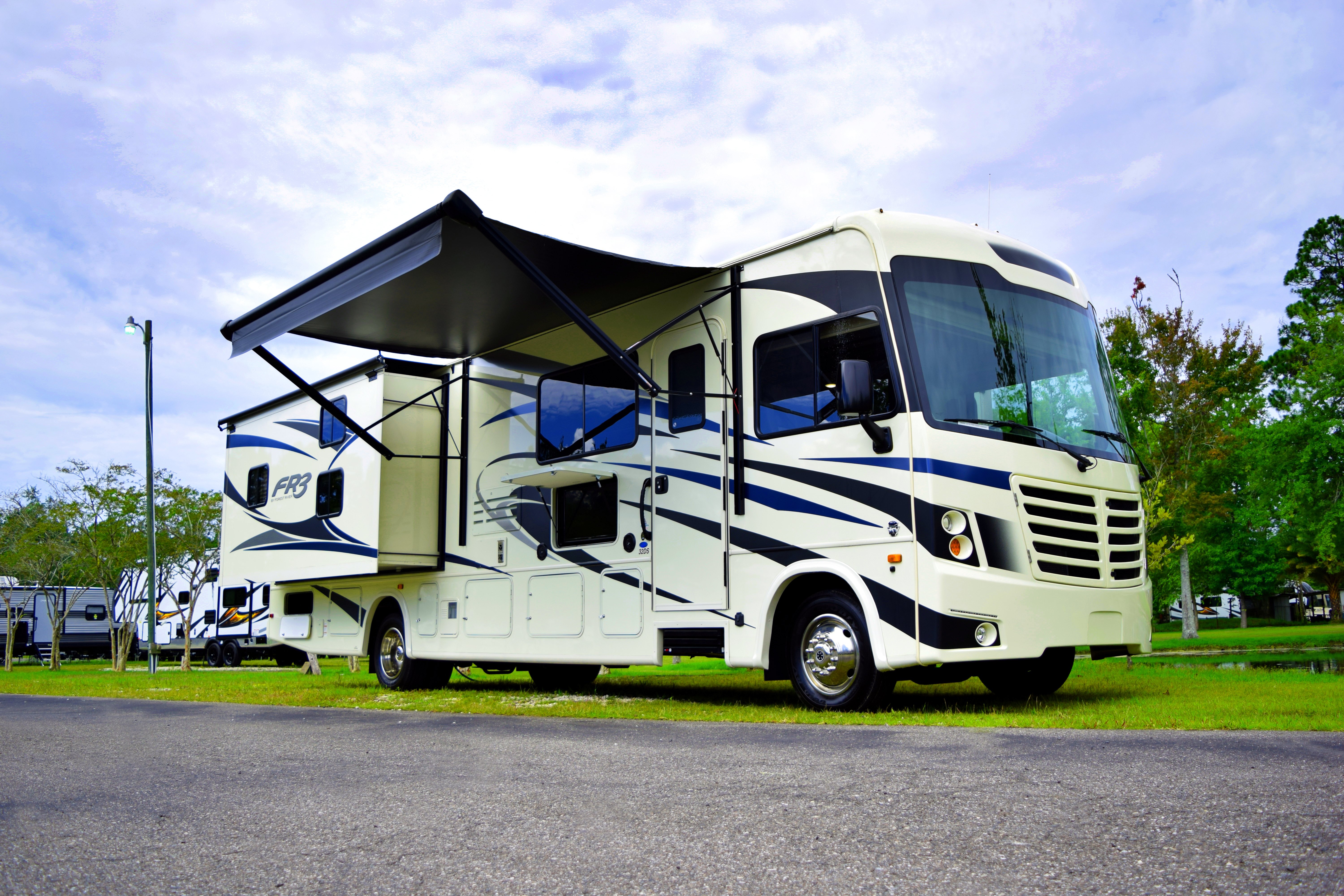 a forest river fr3 class a motorhome set up at a campsite