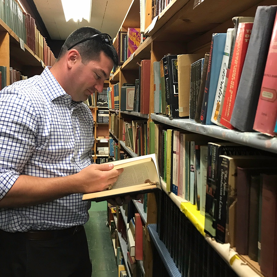 Campers Inn RV COO Ben Hirsch reads a book at a diner/bookstore in Connecticut