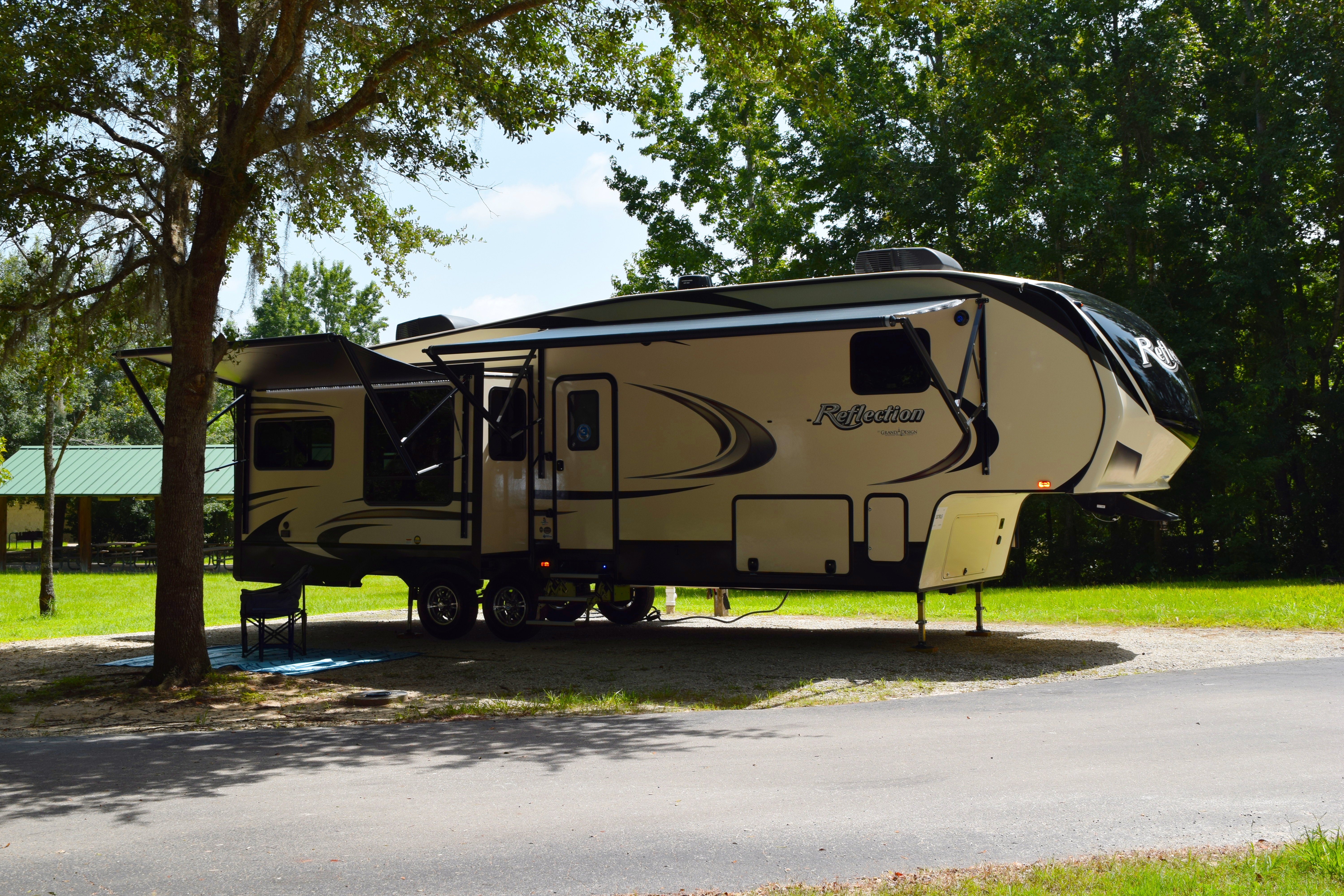 grand design reflection fifth wheel at a campsite