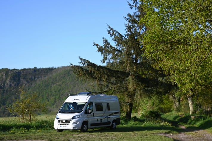 Motorhome parked in wooded valley