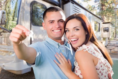 Couple poses in front of their new RV