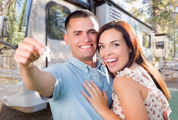 Couple poses in front of their new RV