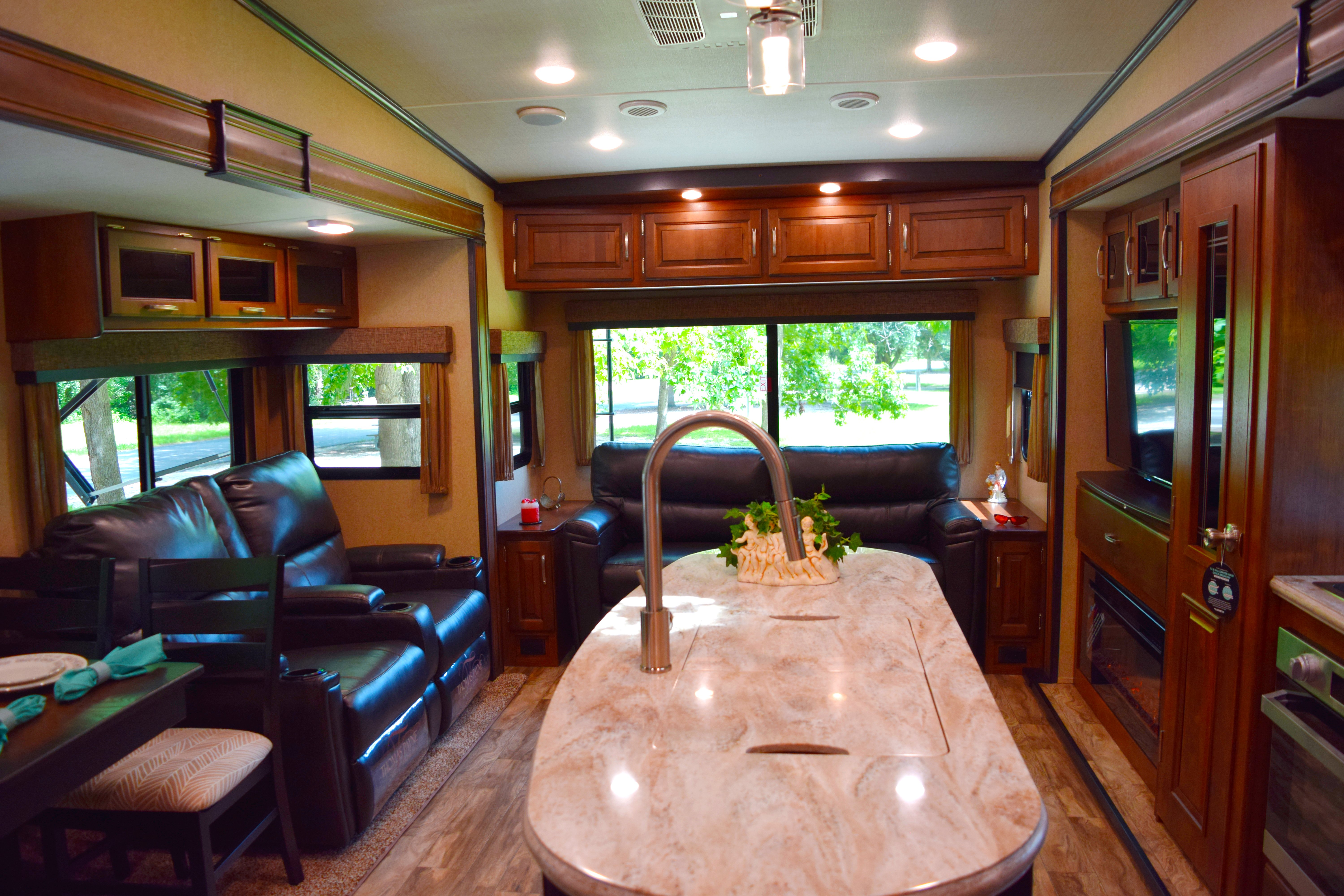 grand design reflection fifth wheel common area with fireplace and entertainment center