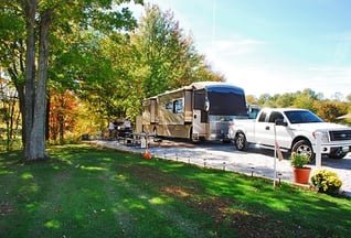 An RV parked in a sunny campsite