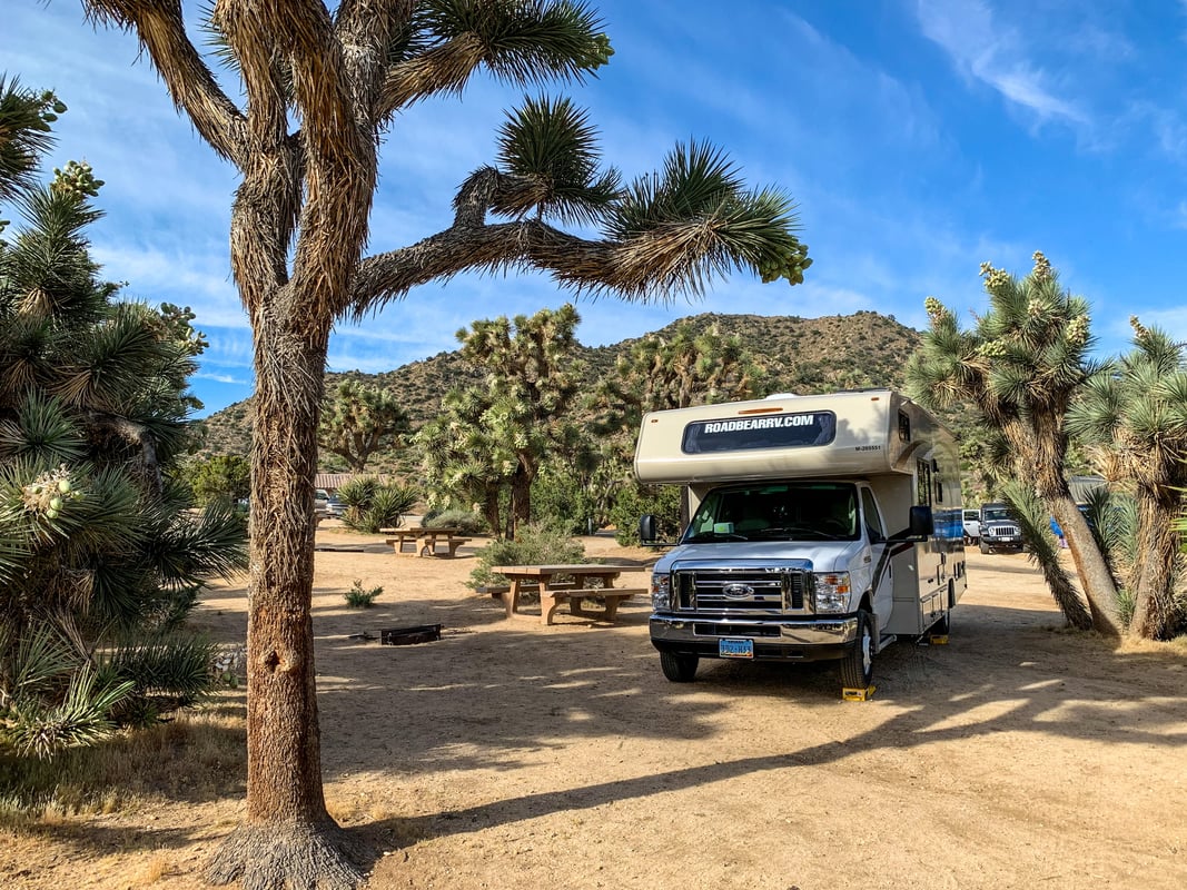 RV camper parked outside a scenic desert campground 