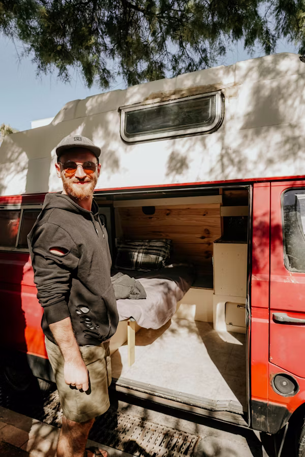 yound_white_man_shows_inside_of_old_camper_van